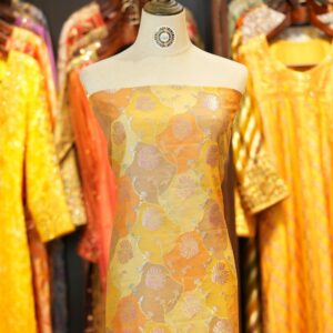 Amber orange and yellow Rangkaat silk fabric with silver and pink zari floral weave