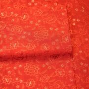 Deep saffron red embroidered pure silk fabric with delicate floral motifs and sequin highlights