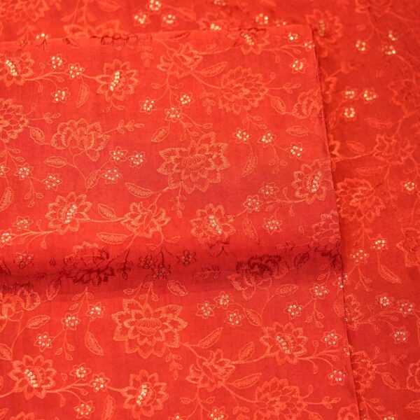 Deep saffron red embroidered pure silk fabric with delicate floral motifs and sequin highlights