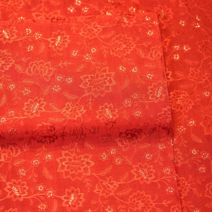 Deep saffron red embroidered pure silk fabric with delicate floral motifs and sequin highlights
