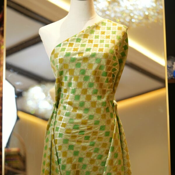 Pure cotton fabric with Rangkaat-style dyeing, diamond pattern, and golden zari weave in green and mustard tones