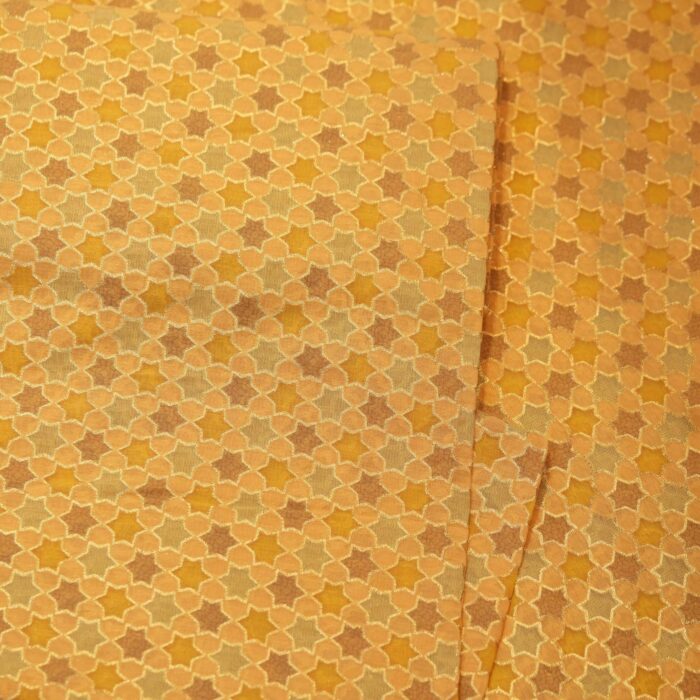 Pure cotton jacquard fabric with six-pointed star geometric motif and zari weave in golden and beige tones