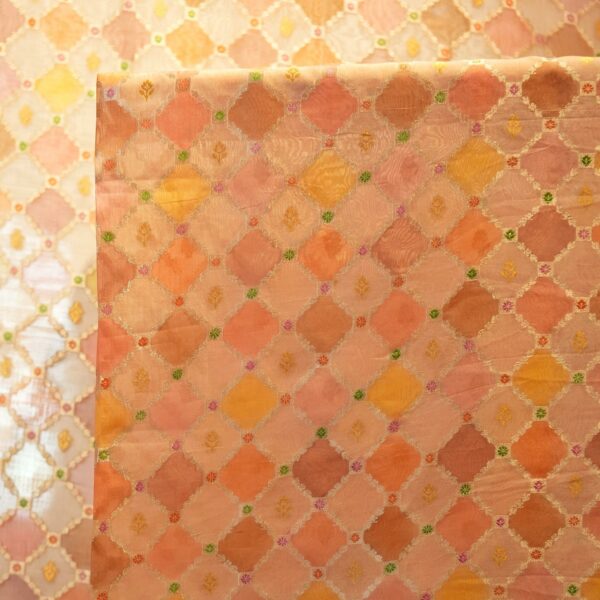 Peach and saffron pure organza Rangkaat fabric with golden zari diamond pattern and multicolor minakari motifs