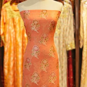 Peach coral khaddi chiffon fabric with hand-brushed dye and floral boota motifs with zari accents