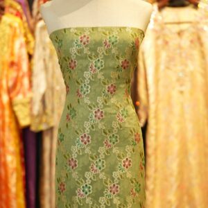 Green khaddi chiffon fabric with multicolored floral boota and hand-brush dye finish with zari highlights.