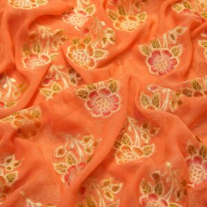 Peach coral khaddi chiffon fabric with hand-brushed dye and floral boota motifs with zari accents