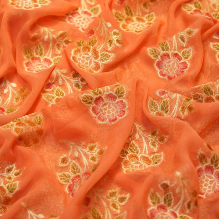 Peach coral khaddi chiffon fabric with hand-brushed dye and floral boota motifs with zari accents
