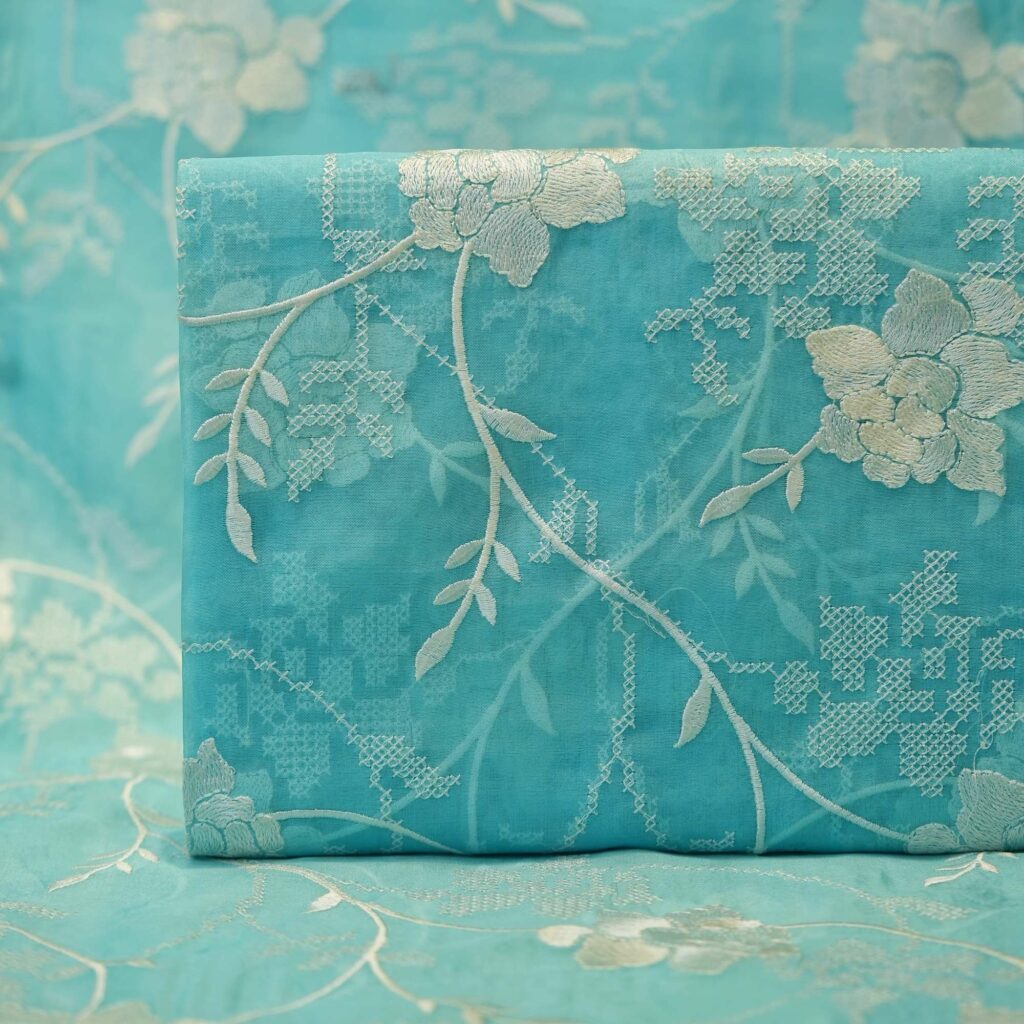 Turquoise pure organza fabric with ivory floral embroidery – sheer designer material for elegant kaftans and overlays