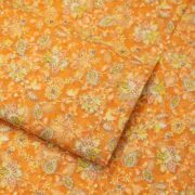 Golden orange pure organza fabric with intricate floral embroidery and shimmering crystal highlights – luxury festive material
