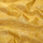 Golden yellow pure organza fabric with circular floral embroidery and delicate leafy weaves