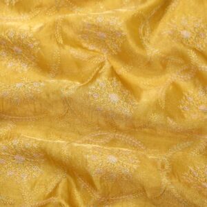 Golden yellow pure organza fabric with circular floral embroidery and delicate leafy weaves