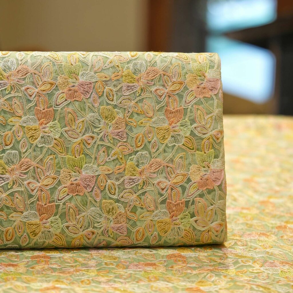 Pastel hand-brushed pure organza fabric with floral aari embroidery and intricate jaal design