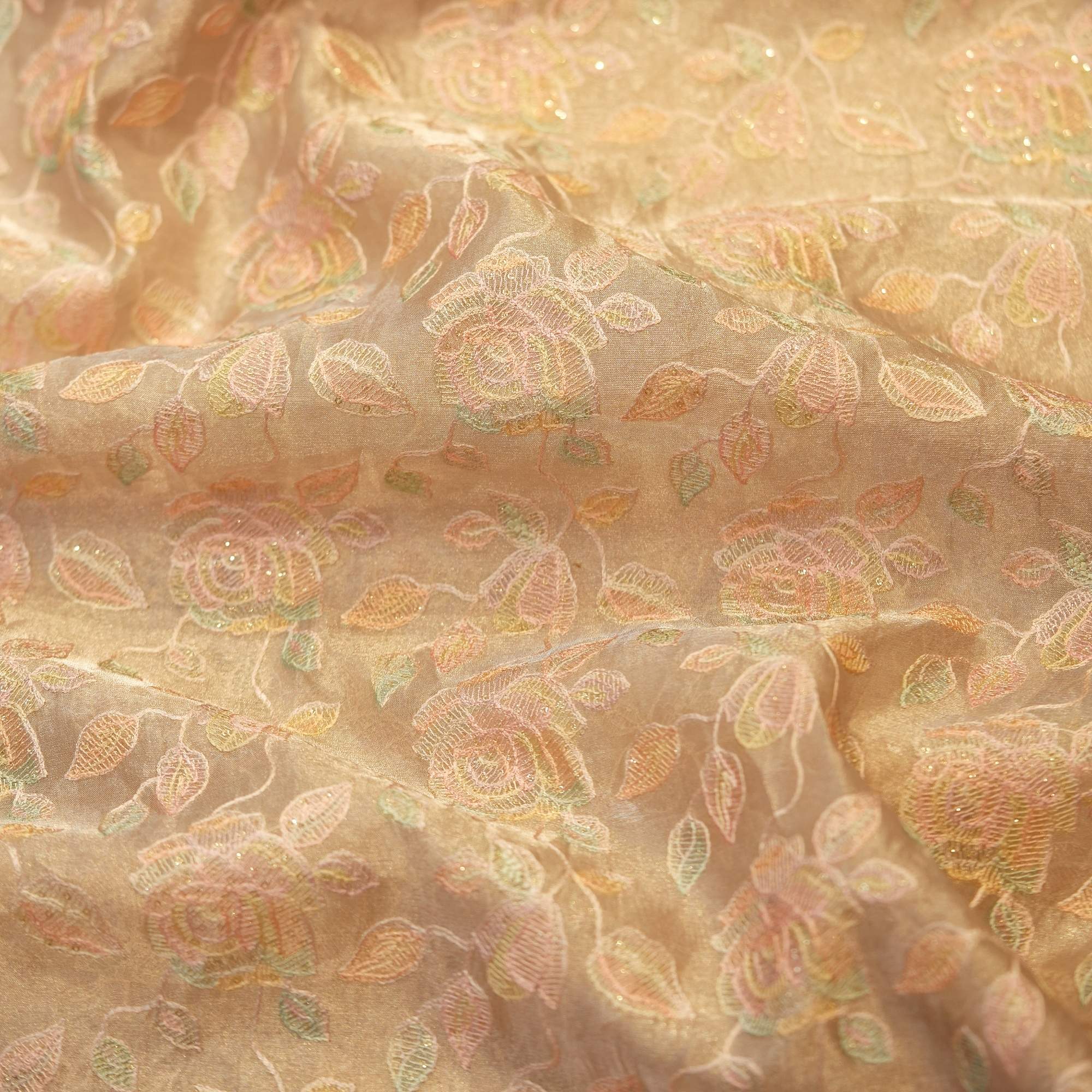 Golden tissue organza fabric with soft pastel floral embroidery and hand-dyed shading – luxury fabric for couture