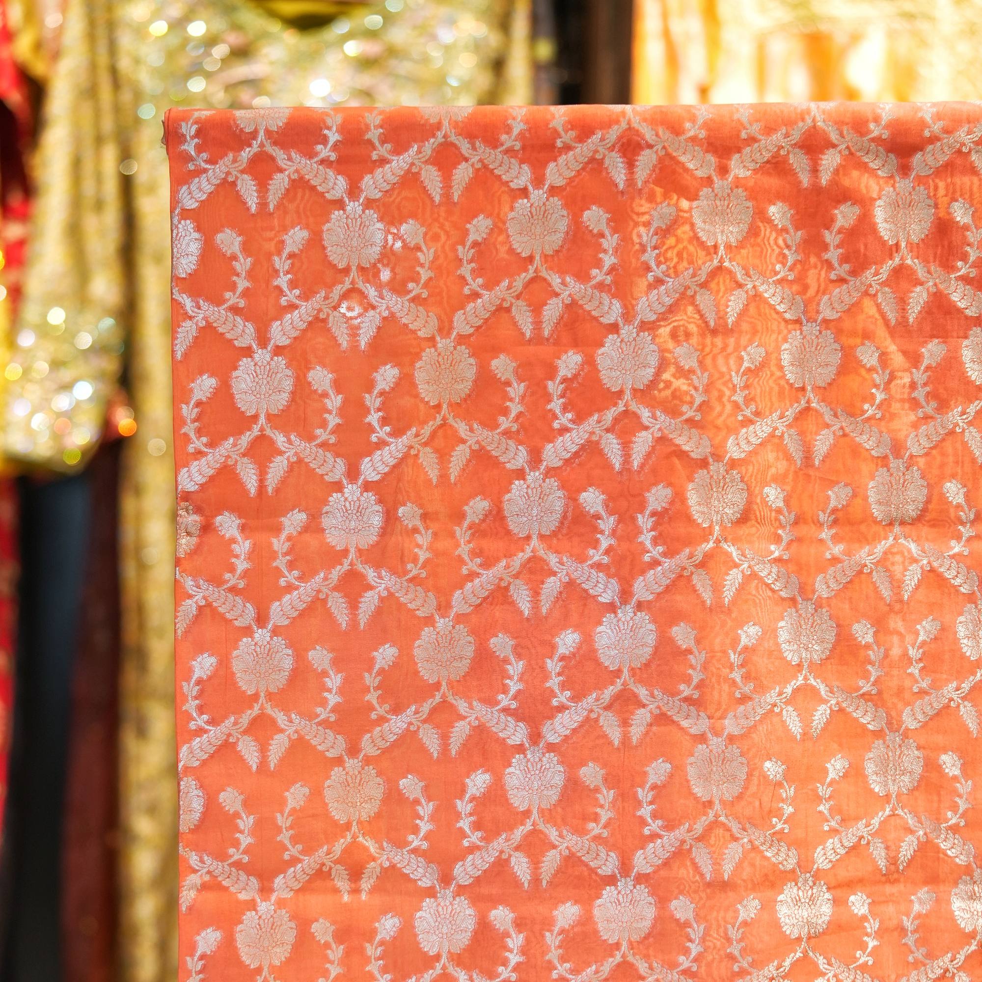 Coral pure organza fabric with silver zari floral jaal weave – luxury couture fabric