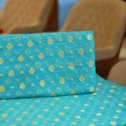 Turquoise blue pure organza fabric with golden zari floral woven motifs