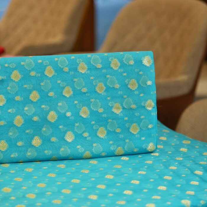 Turquoise blue pure organza fabric with golden zari floral woven motifs