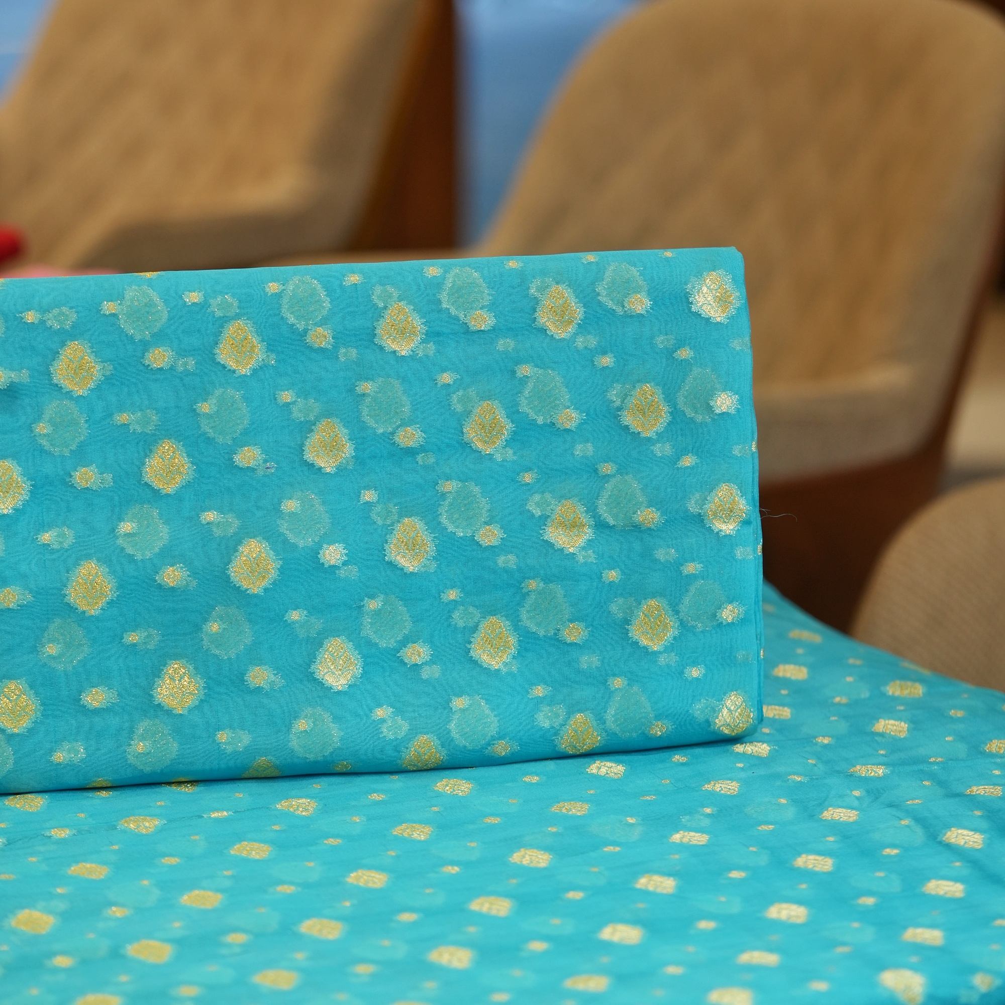 Turquoise blue pure organza fabric with golden zari floral woven motifs