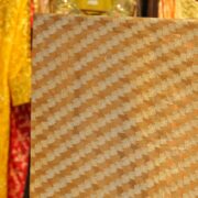 Golden pure organza fabric with cross-stripe zari jaal weave in floral patterns