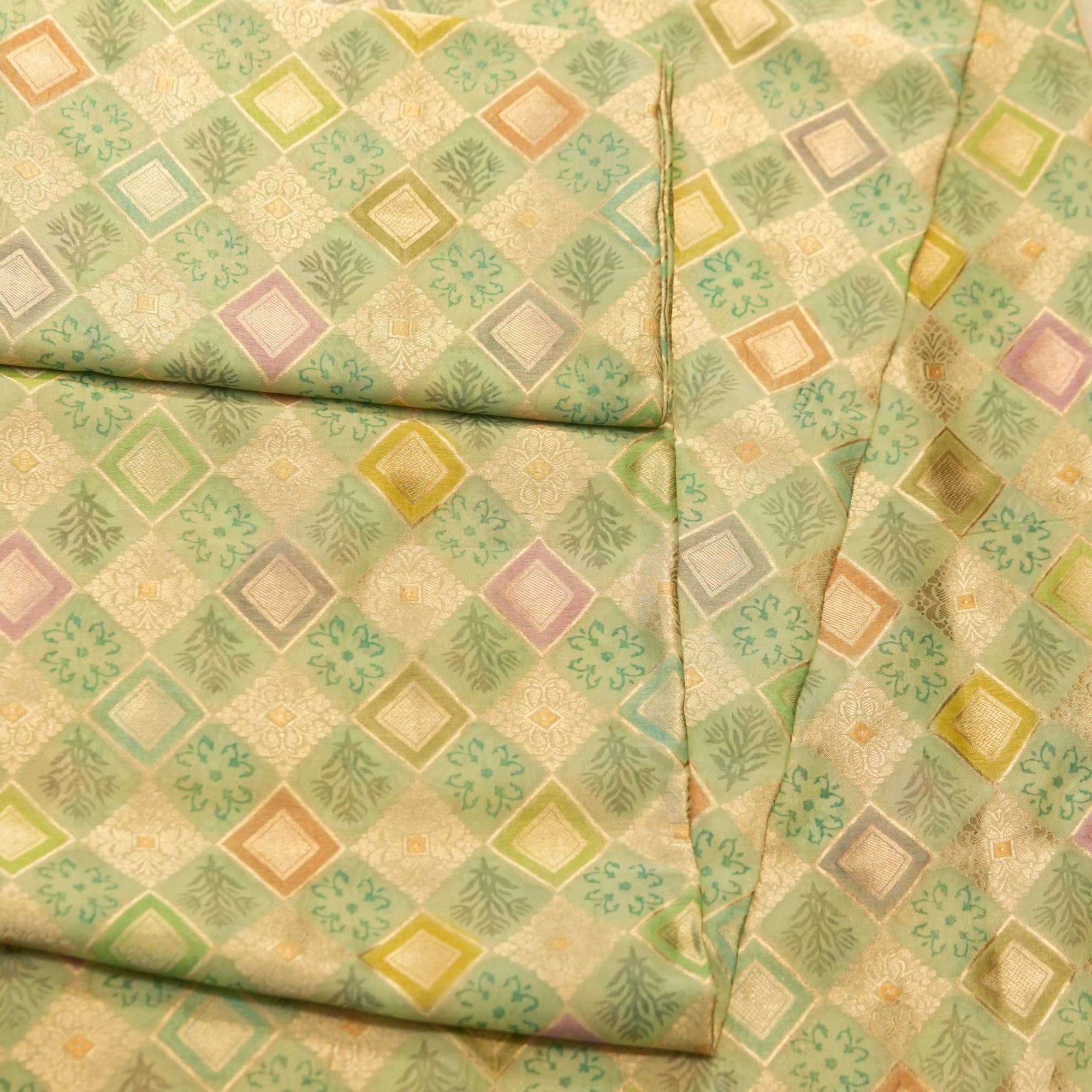 Pure organza fabric with pastel geometric zari weave and floral block motifs