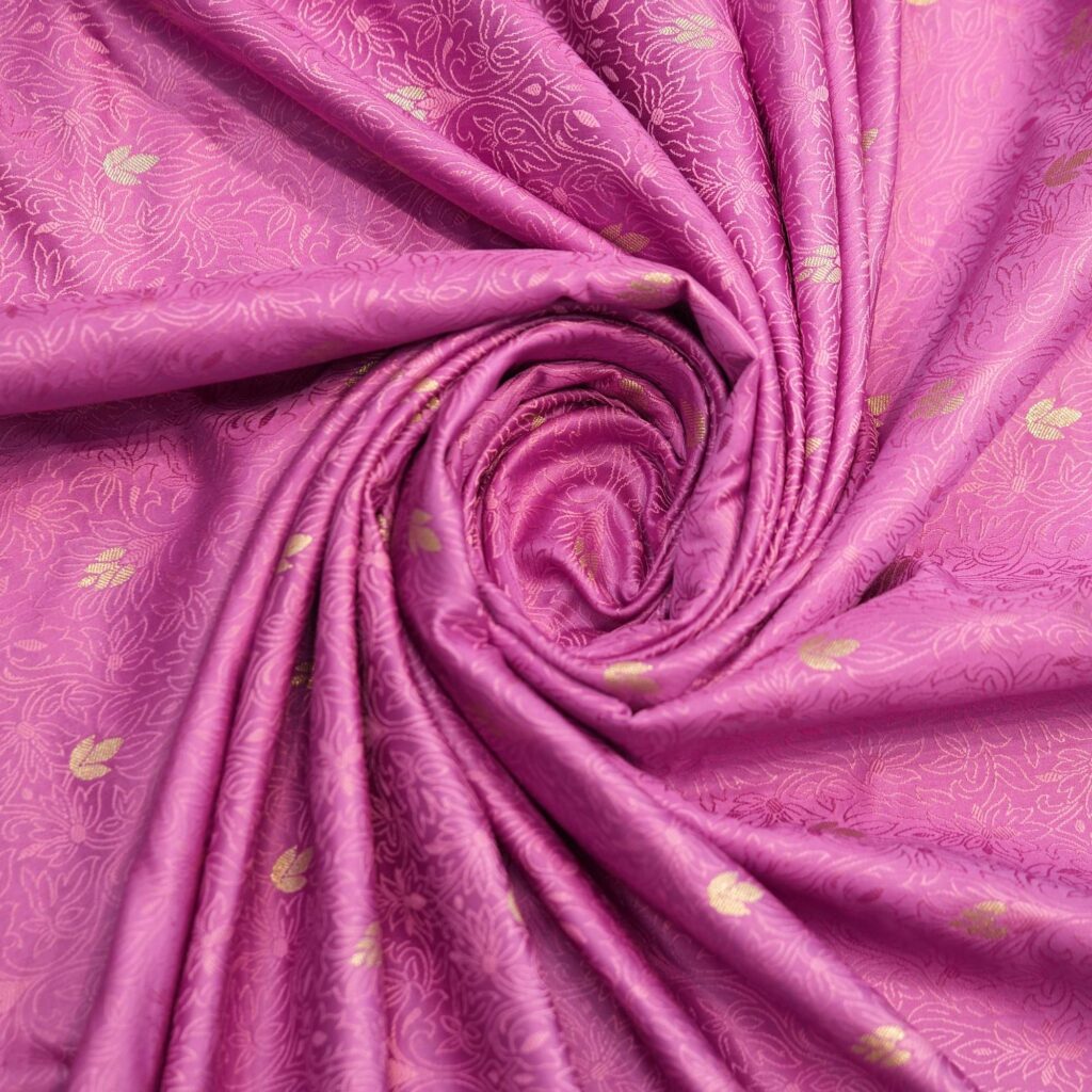 Magenta jamawar silk fabric with golden zari buti and intricate woven base texture