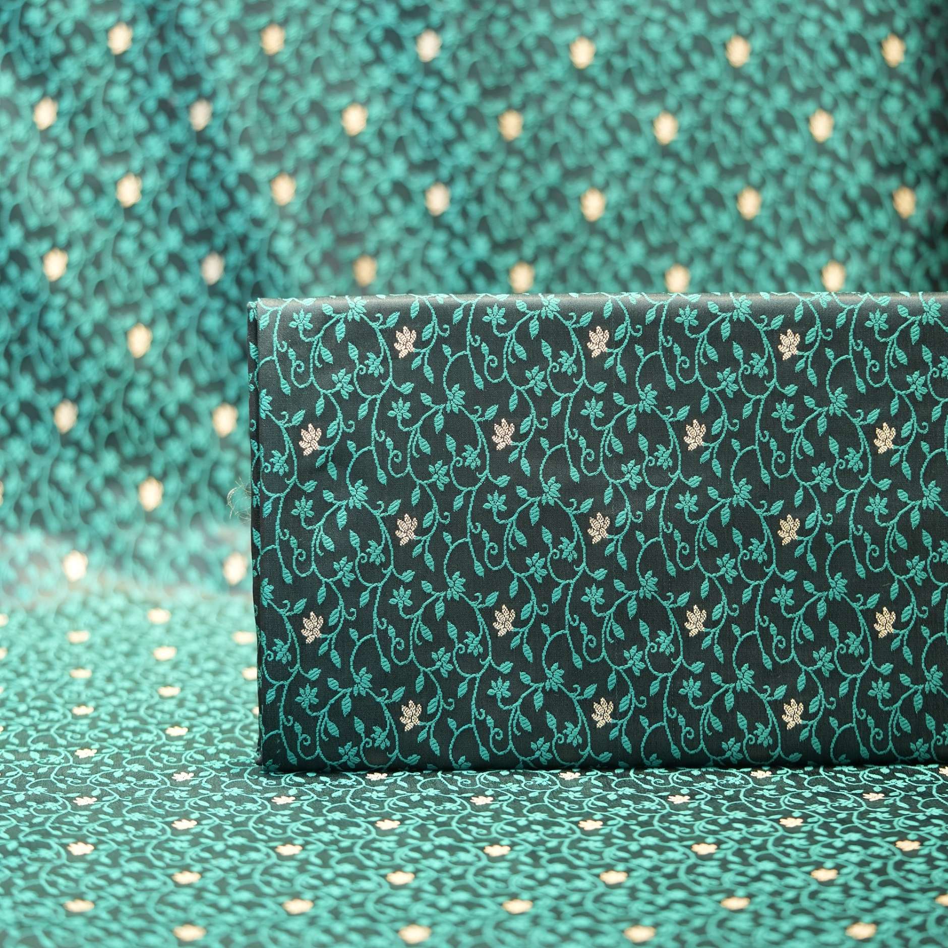 Emerald green jamawar silk fabric with gold floral zari buti and intricate vine pattern