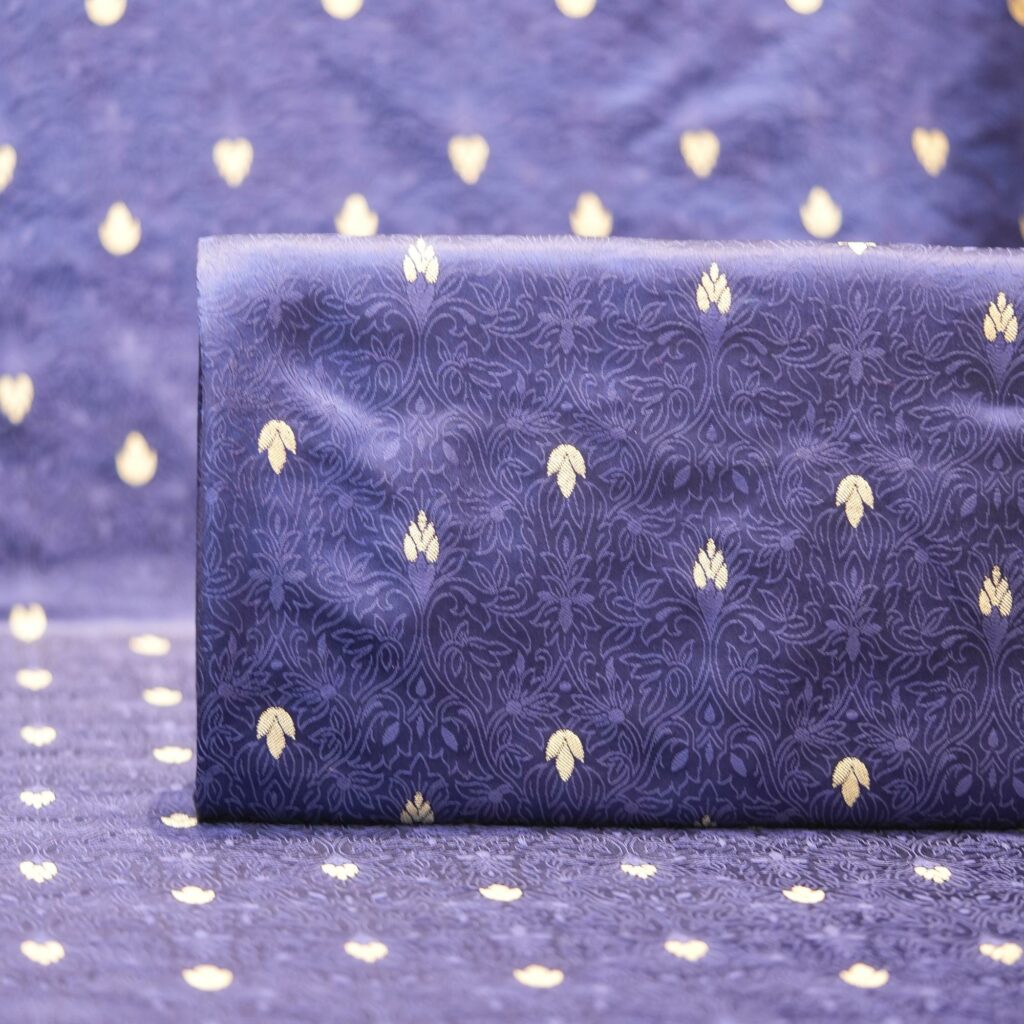 Midnight blue jamawar silk fabric with gold floral zari buti and embossed jacquard pattern