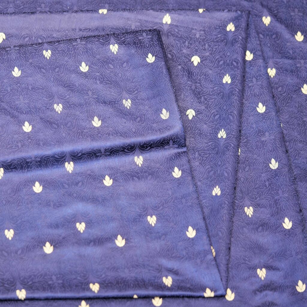 Midnight blue jamawar silk fabric with gold floral zari buti and embossed jacquard pattern
