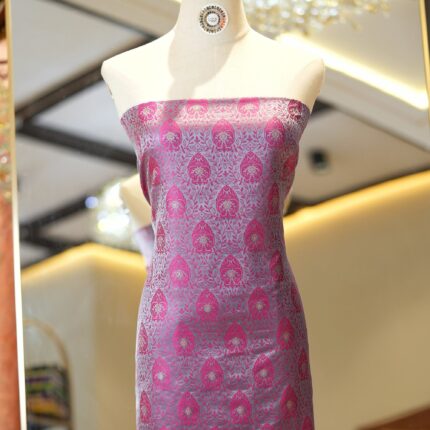 Pink tanchoi silk fabric with intricate jaal weave and subtle golden zari buti