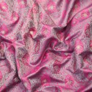 Pink tanchoi silk fabric with intricate jaal weave and subtle golden zari buti