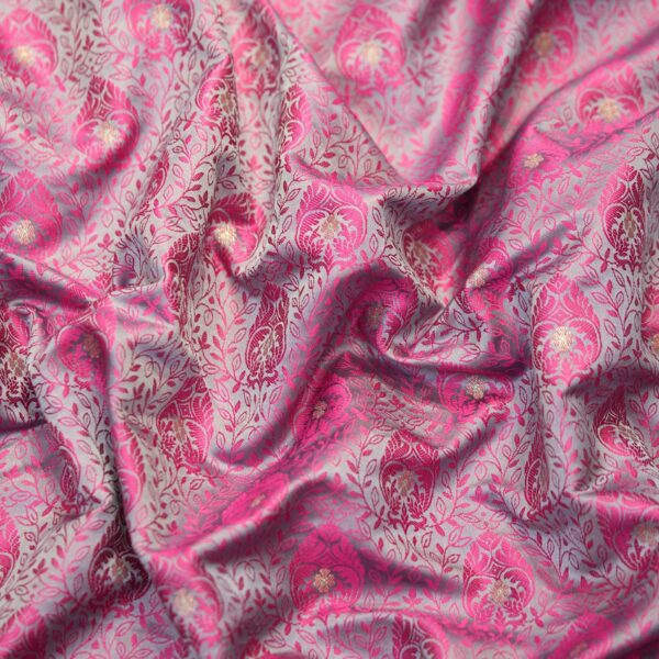 Pink tanchoi silk fabric with intricate jaal weave and subtle golden zari buti