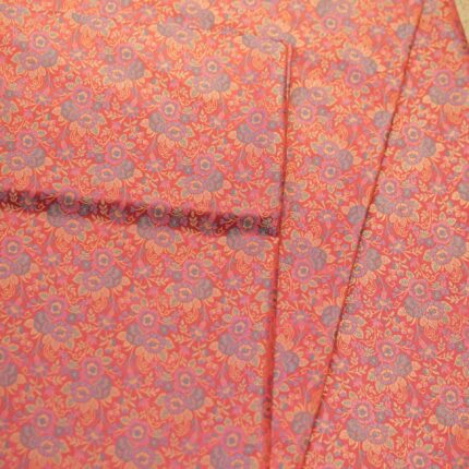 Tanchoi resham silk fabric with intricate floral weaving in crimson, lavender, and gold
