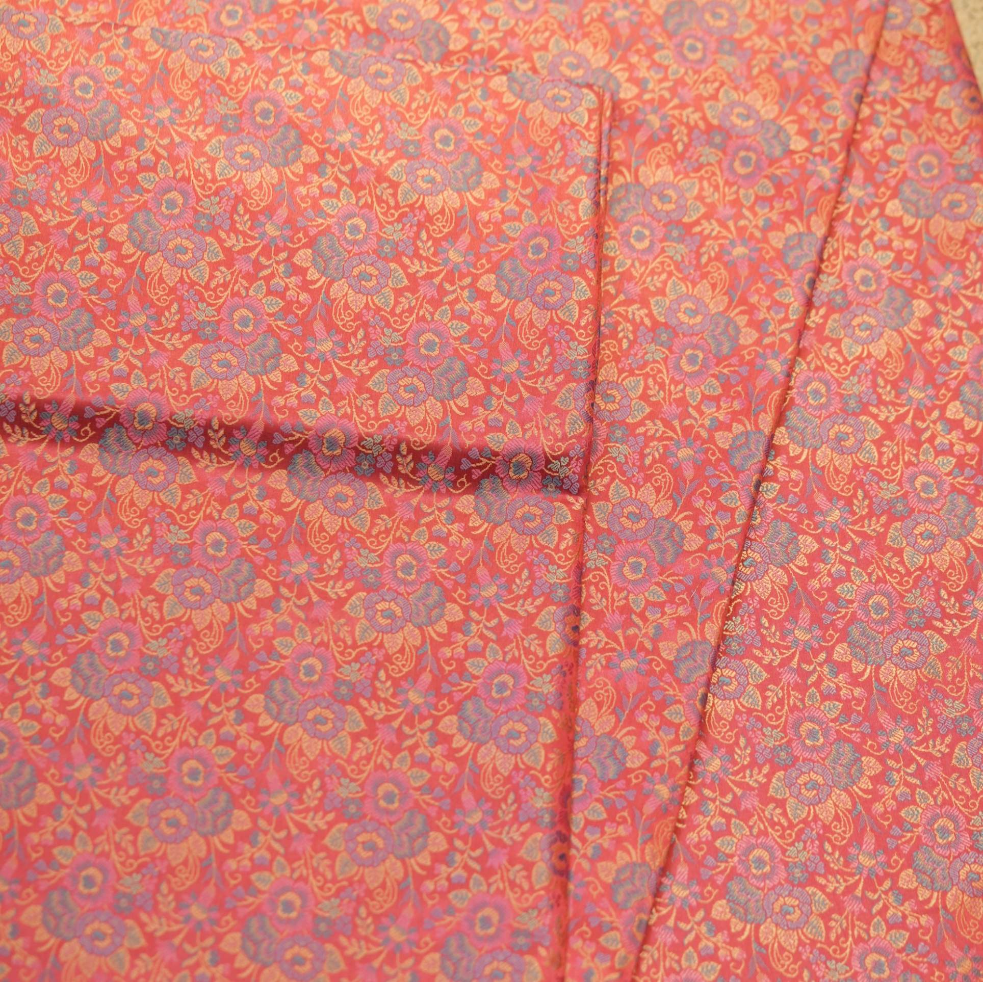 Tanchoi resham silk fabric with intricate floral weaving in crimson, lavender, and gold