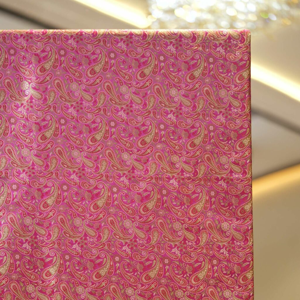 Tanchoi resham silk fabric with rose gold paisley design and intricate weave