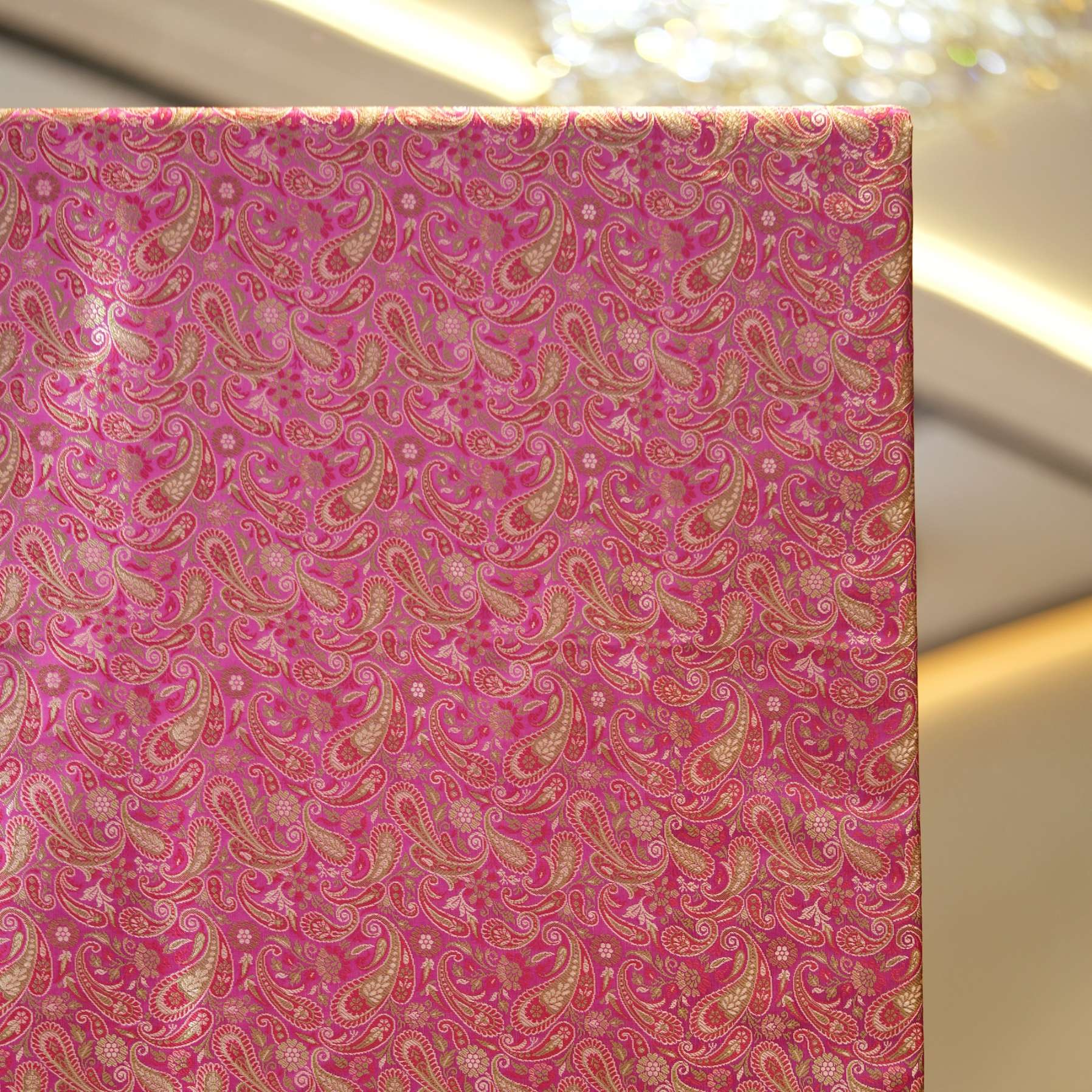 Tanchoi resham silk fabric with rose gold paisley design and intricate weave