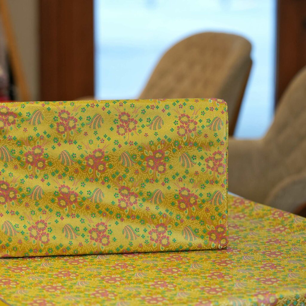 Lime yellow Resham silk fabric with floral motif and delicate multicolor weave