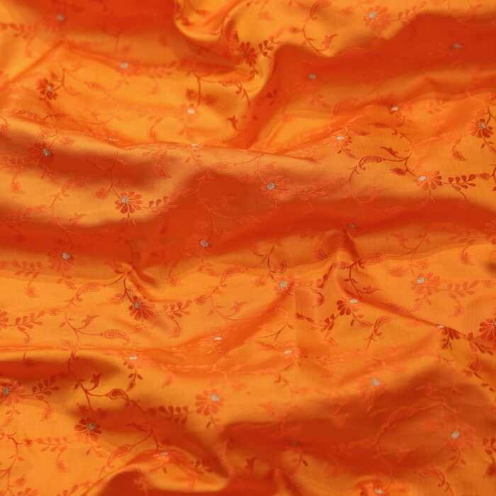 Handloom Tanchoi Jamawar silk in orange with Zari buti and woven floral pattern
