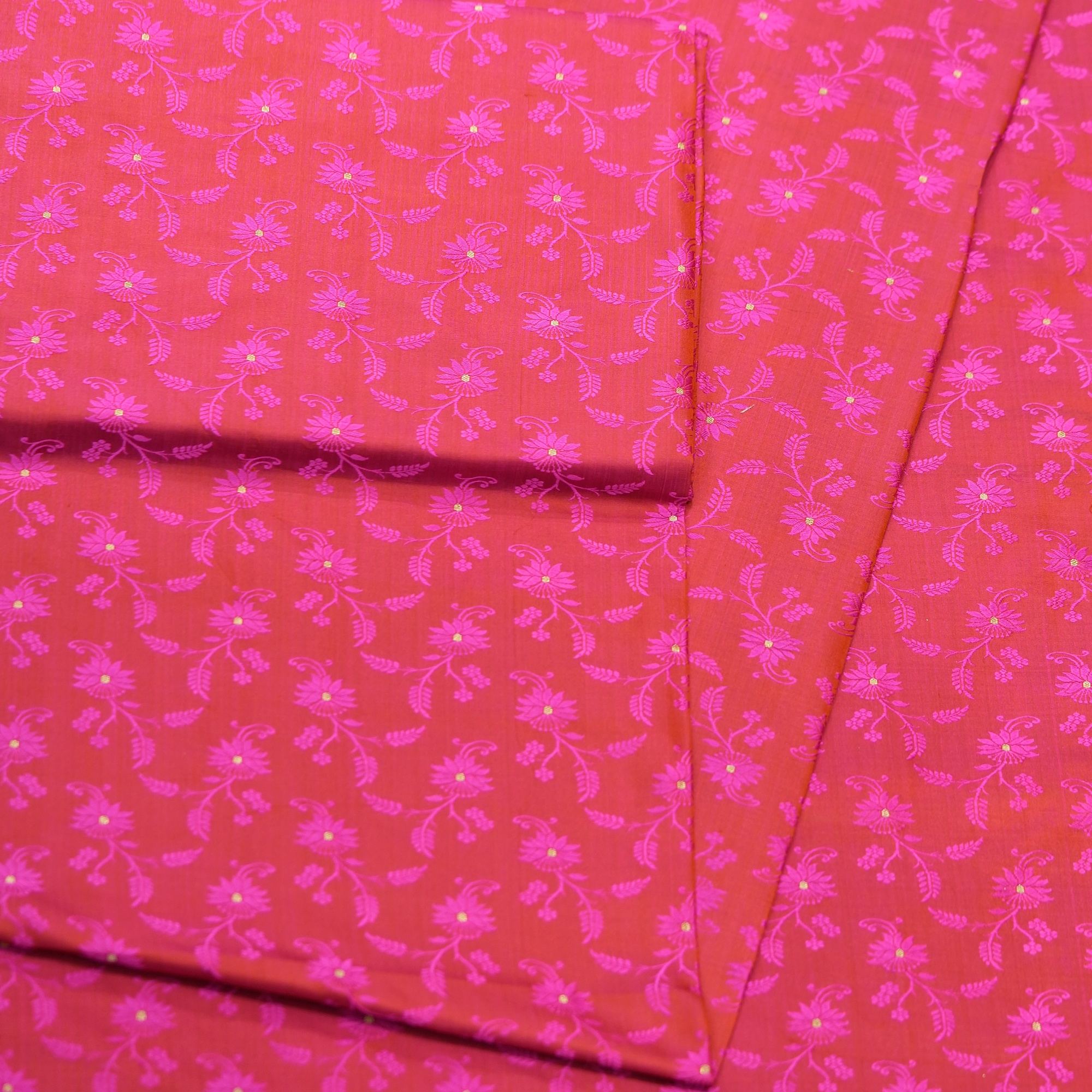 Pure handloom Tanchoi Jamawar silk fabric in pink-magenta with floral weave and golden Zari butis