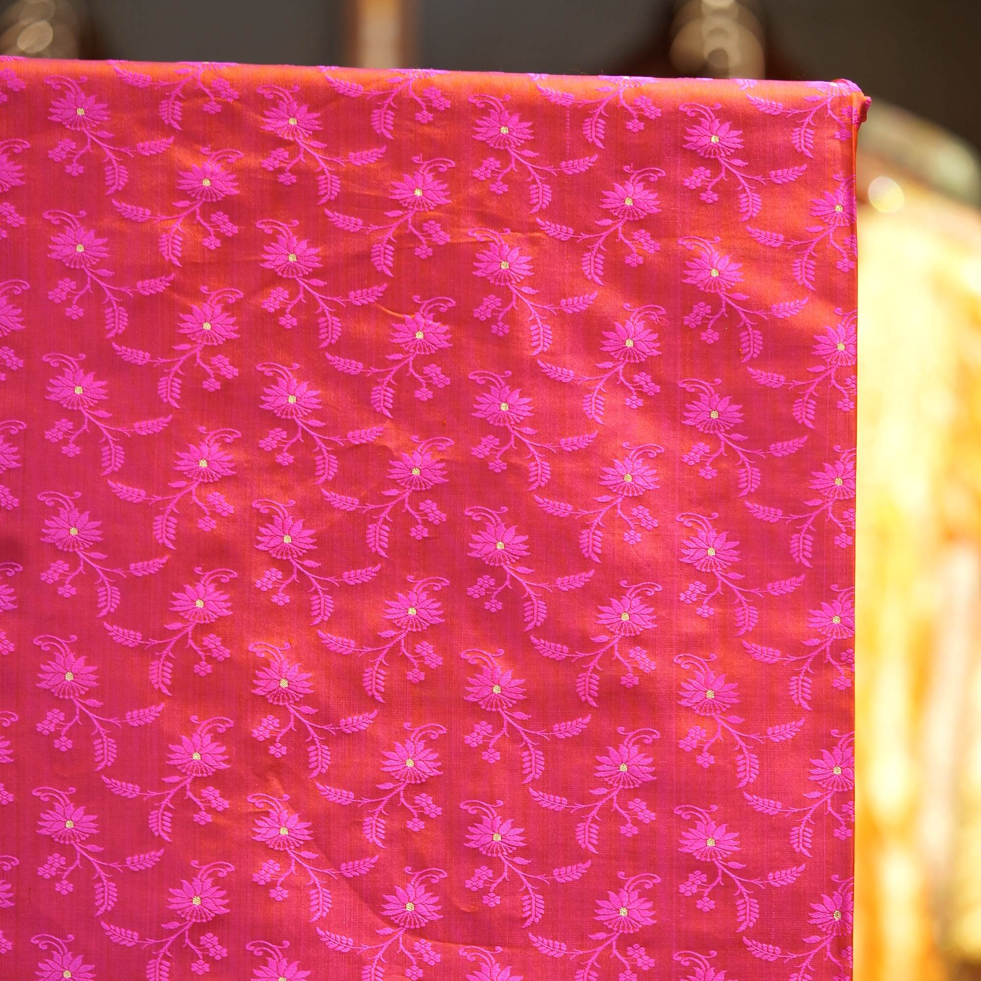 Pure handloom Tanchoi Jamawar silk fabric in pink-magenta with floral weave and golden Zari butis