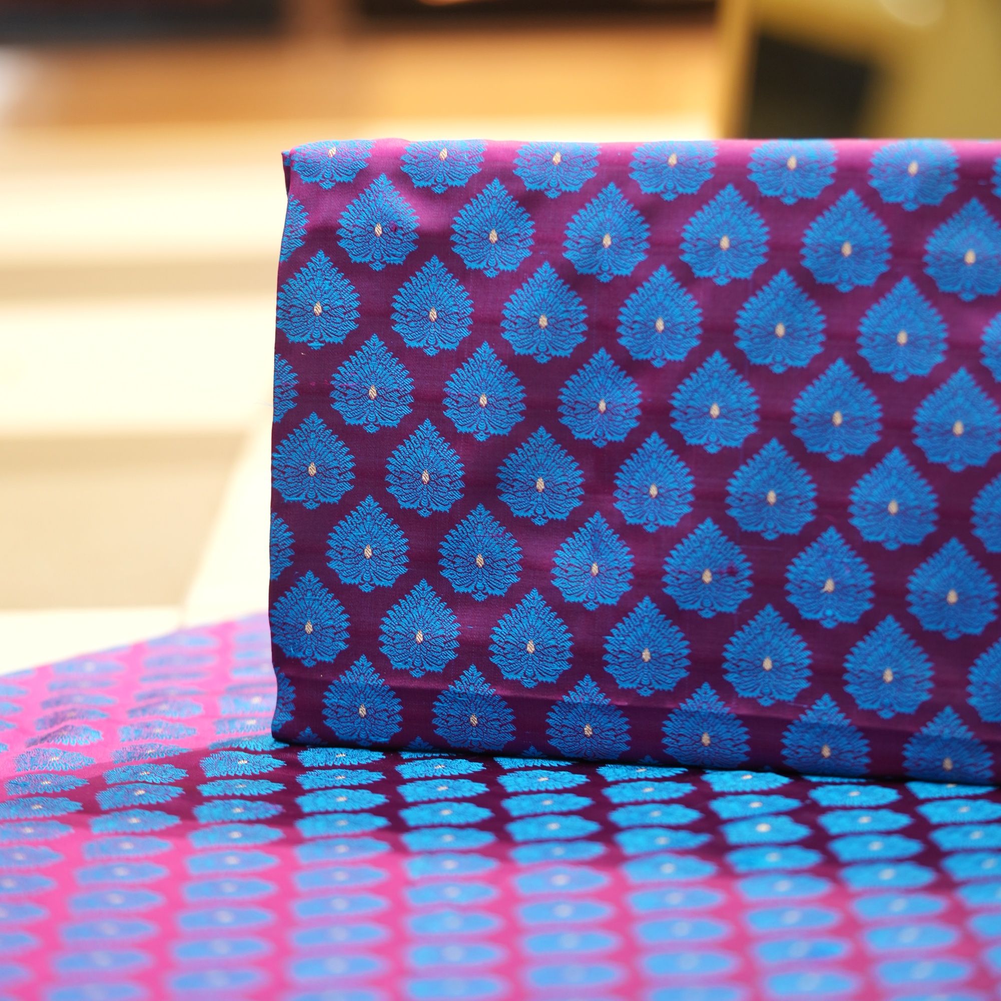 Pure handloom Tanchoi Jamawar resham silk fabric with Mughal blue leaf motifs on deep magenta base