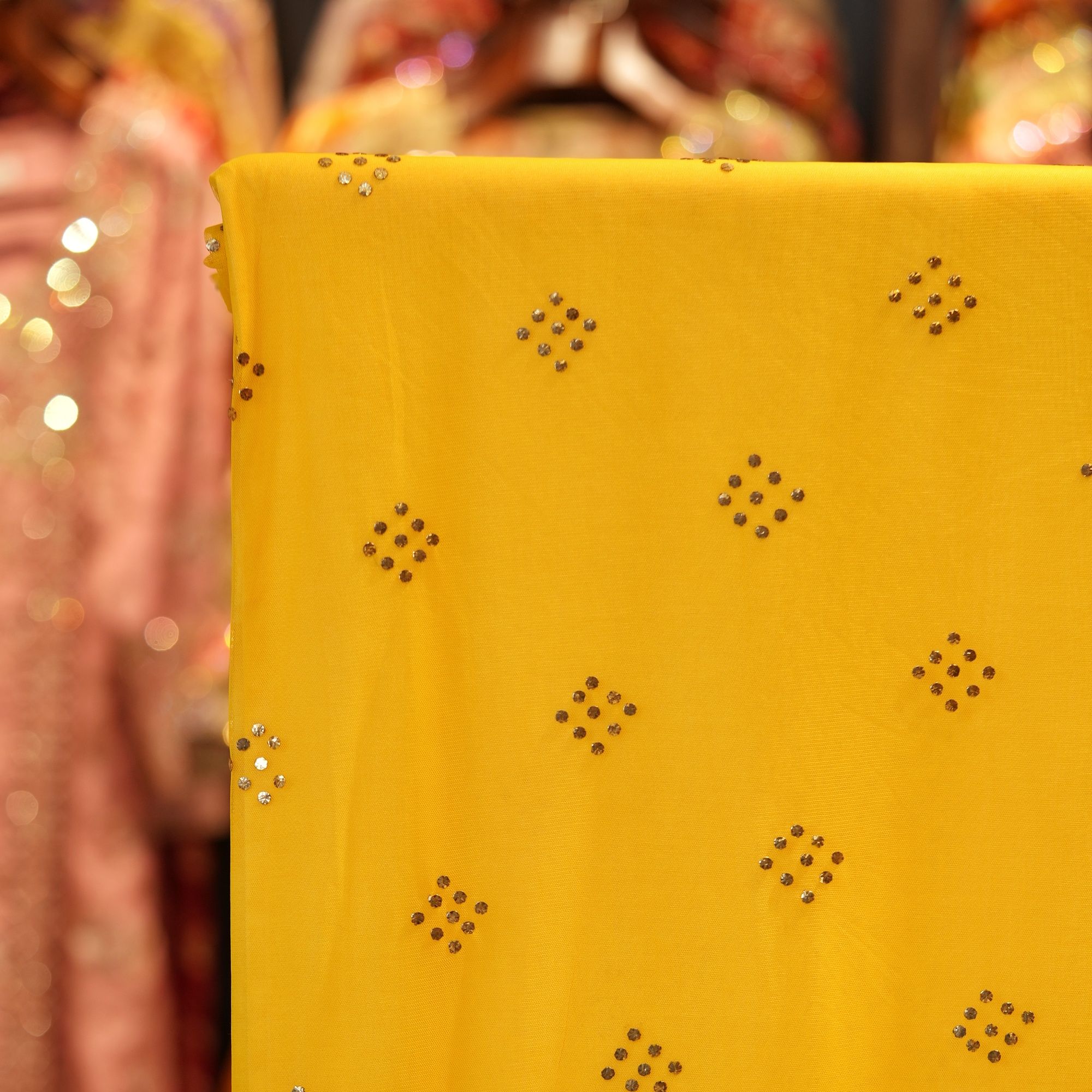 Yellow net fabric with gold mukaish diamond-shaped bootis
