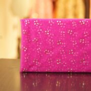 Pink net fabric with gold mukaish work in clustered dot pattern