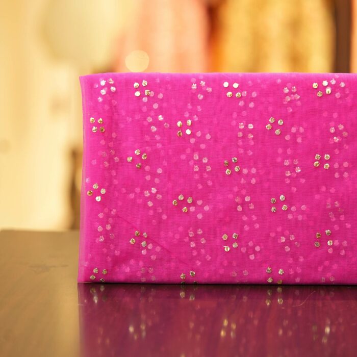 Pink net fabric with gold mukaish work in clustered dot pattern