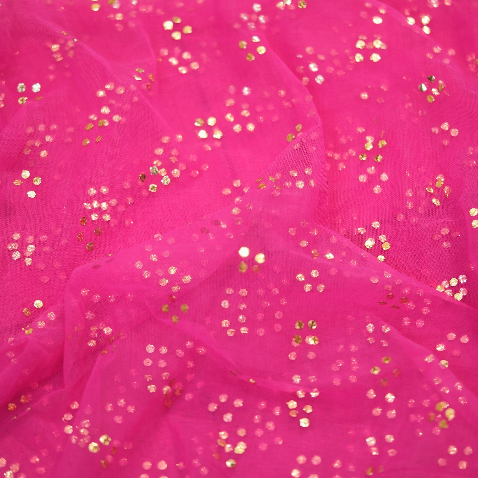 Pink net fabric with gold mukaish work in clustered dot pattern