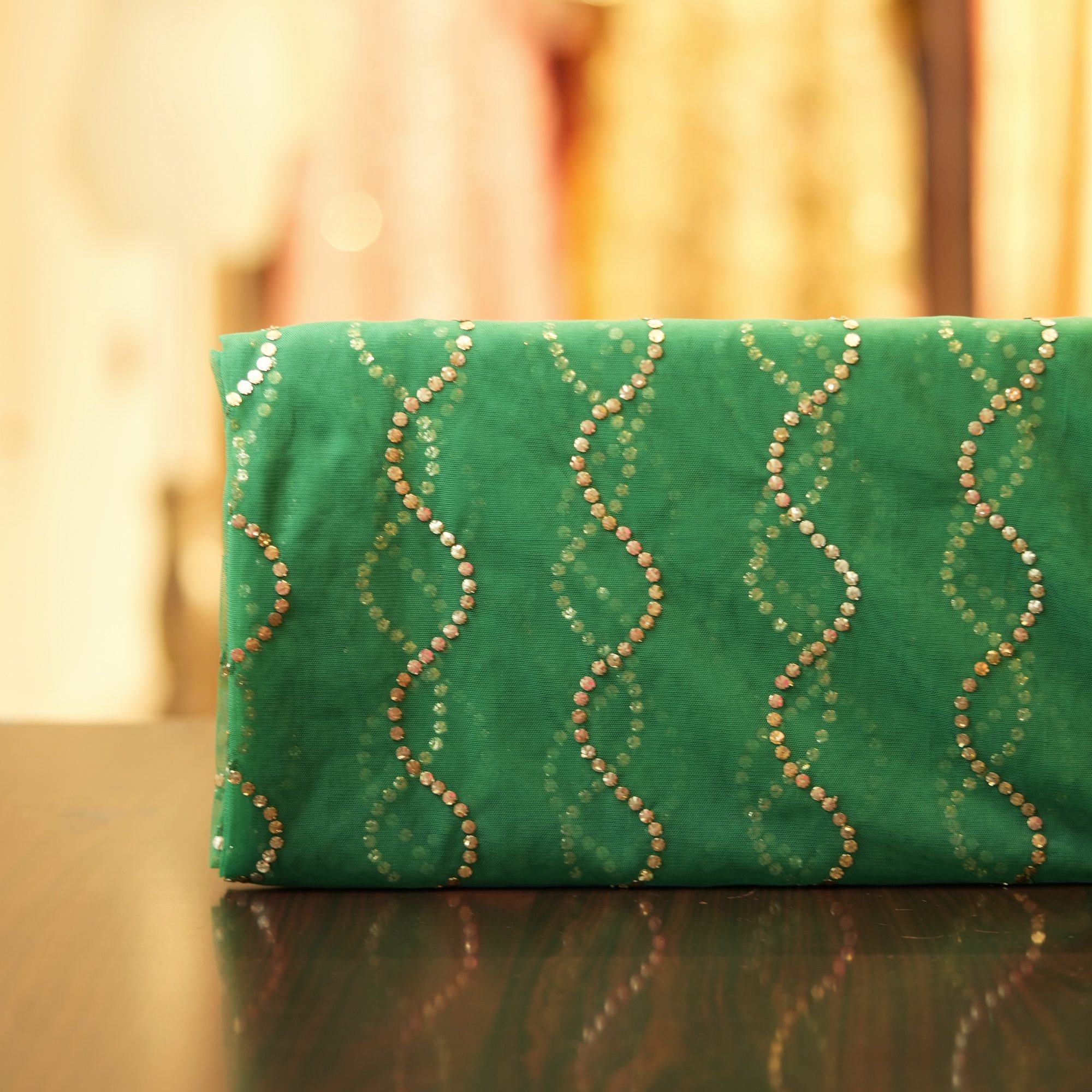 Green net fabric with zigzag mukaish embroidery pattern