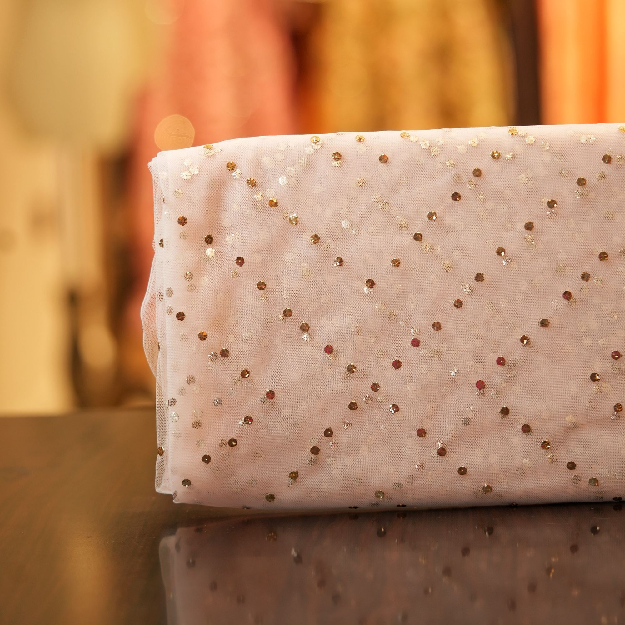 Blush pink net fabric with handcrafted mukaish work in geometric pattern