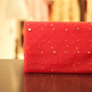 Red net fabric with scattered raindrop-style mukaish embroidery