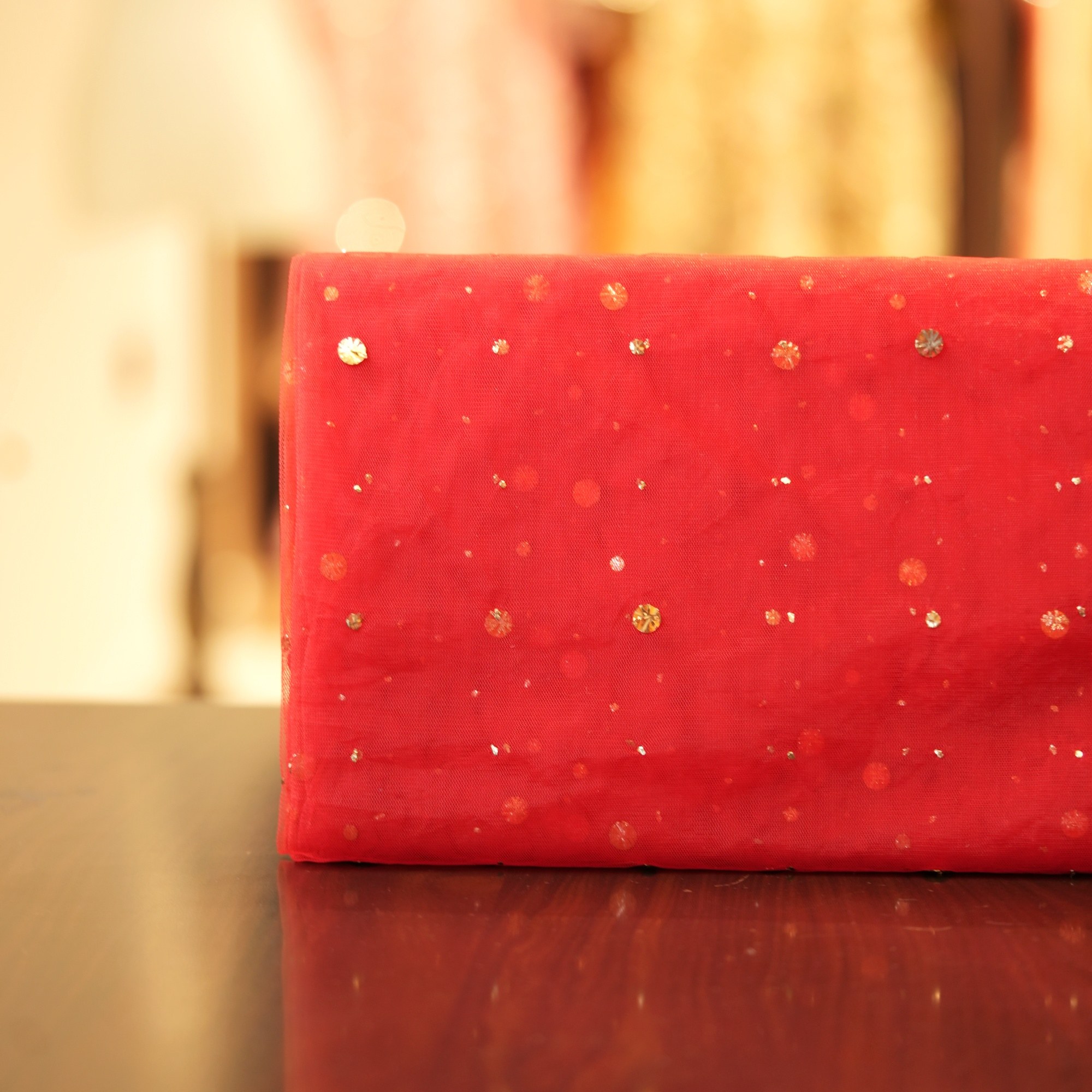 Red net fabric with scattered raindrop-style mukaish embroidery