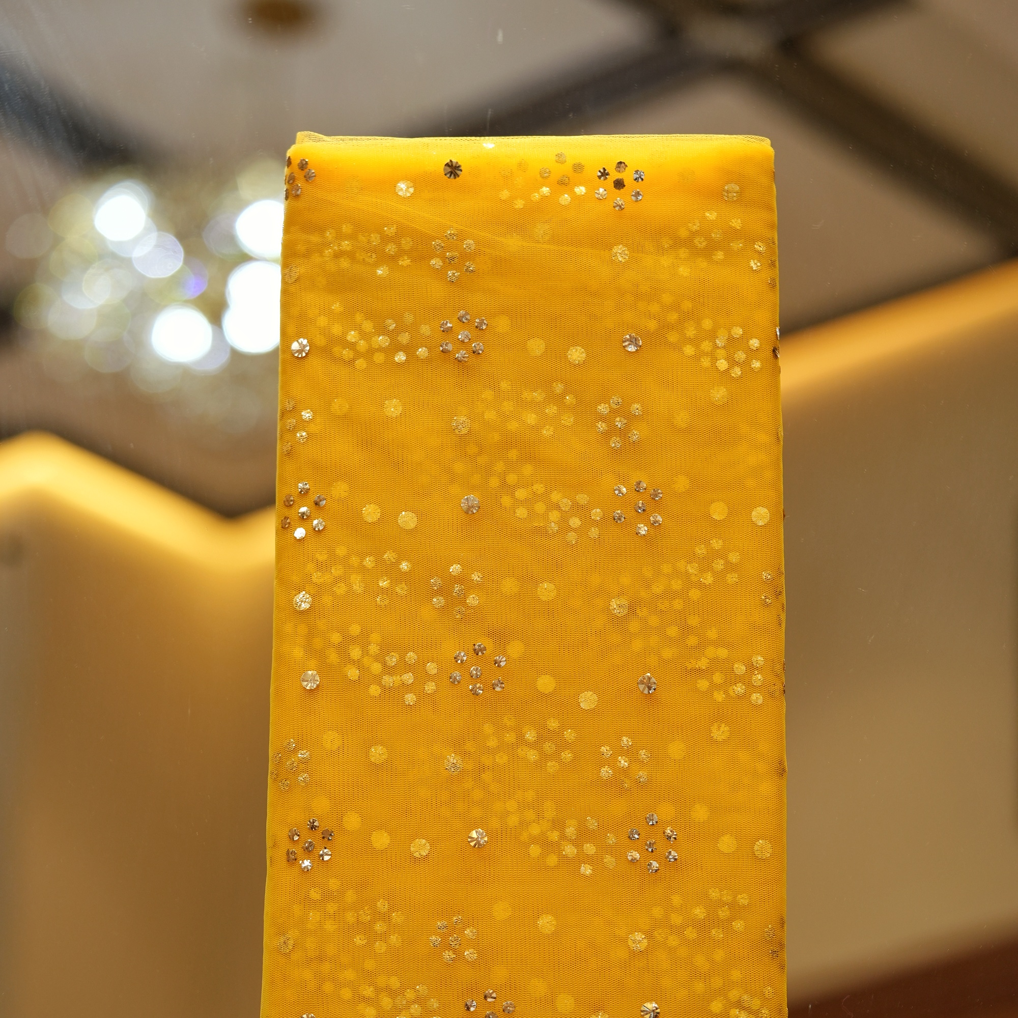 Yellow net fabric with gold mukaish floral clusters