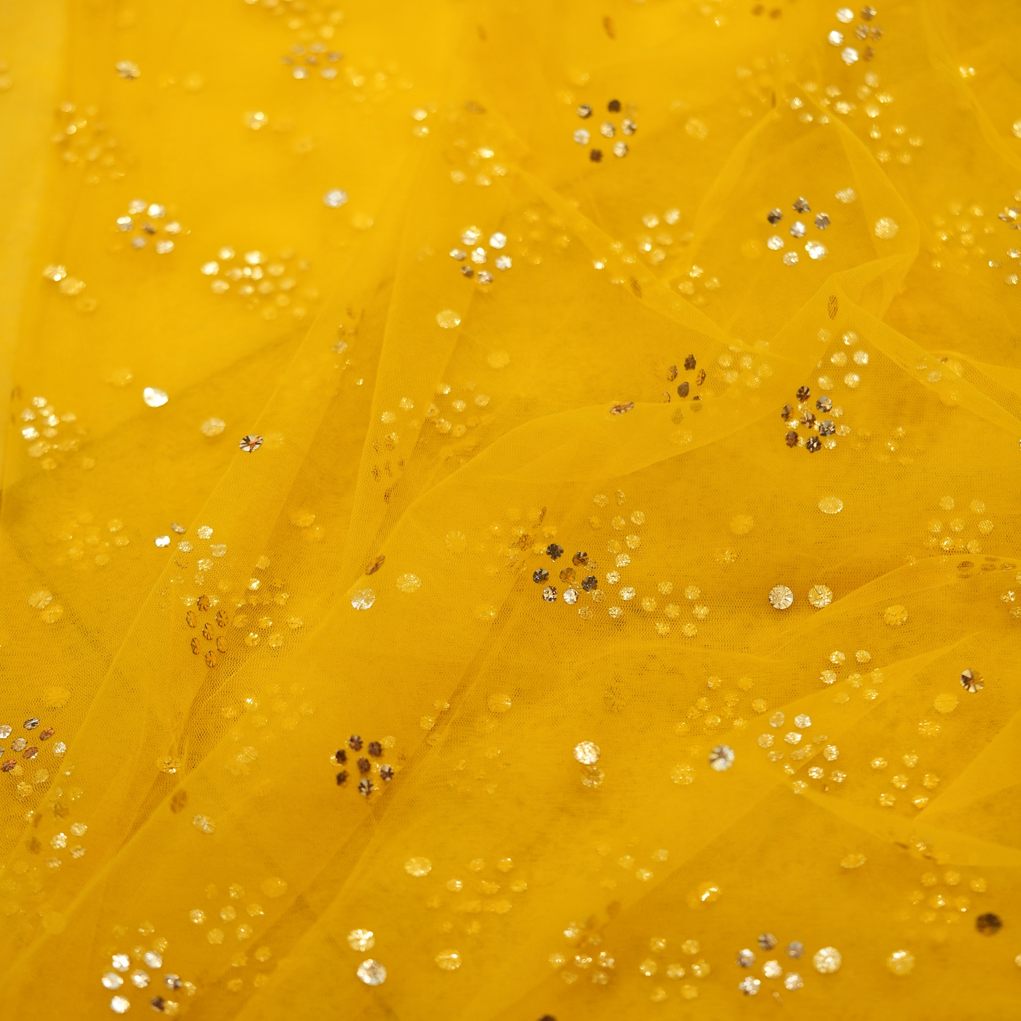 Yellow net fabric with gold mukaish floral clusters
