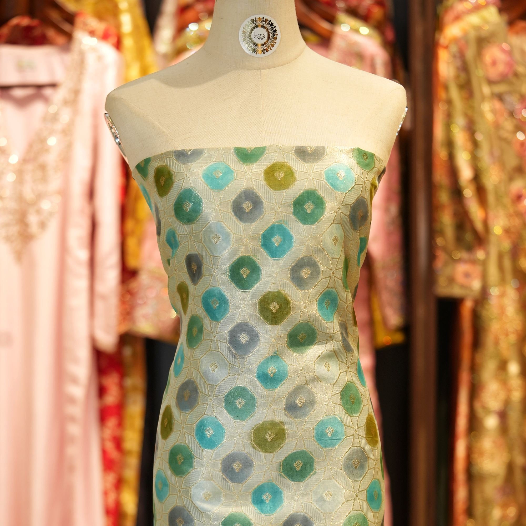 Katan silk fabric with golden Zari weave and green-teal Rangkaat dye in octagonal motifs